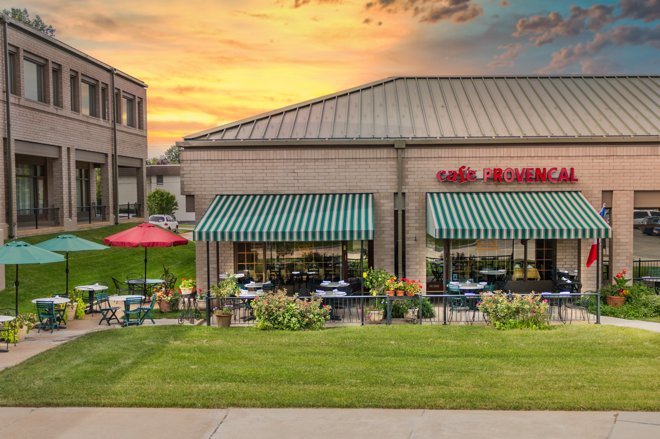 Exterior image of restaurant with grass and outside seating visible